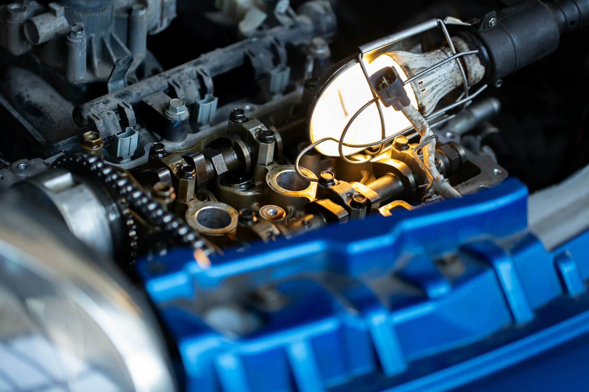 Master, car mechanic repairs the car engine at the service station